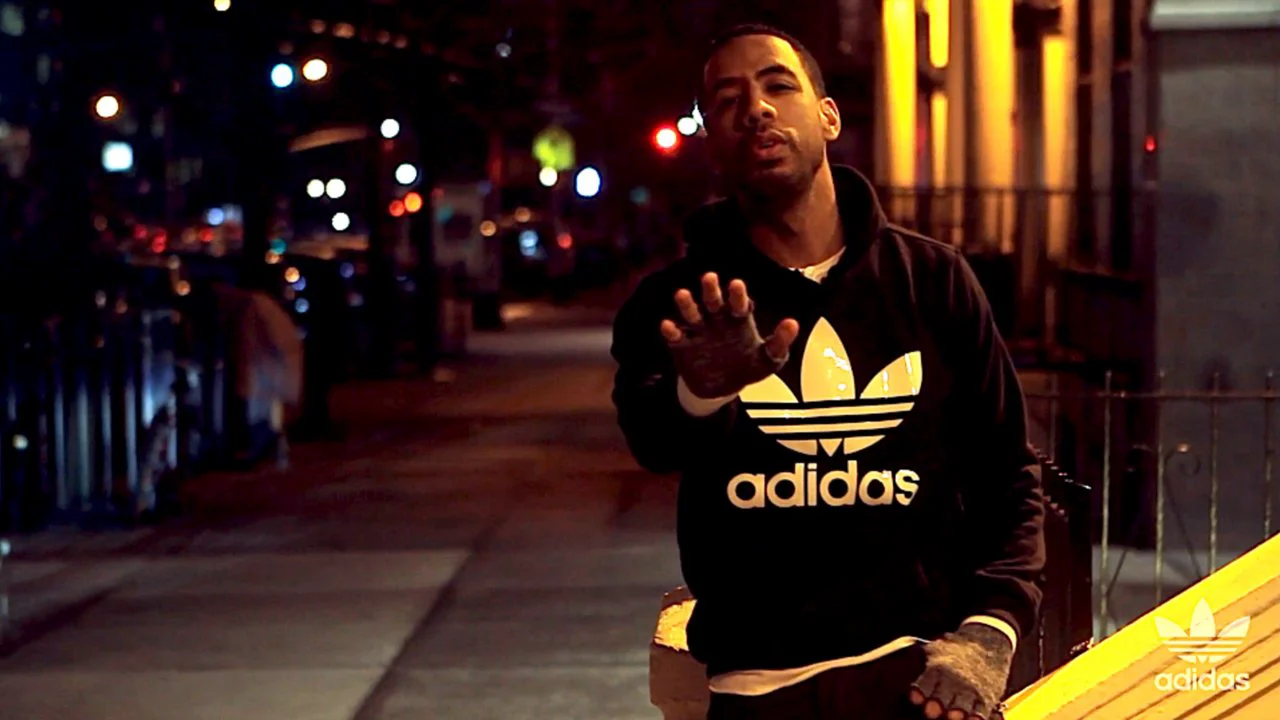 man wearing original adidas at night