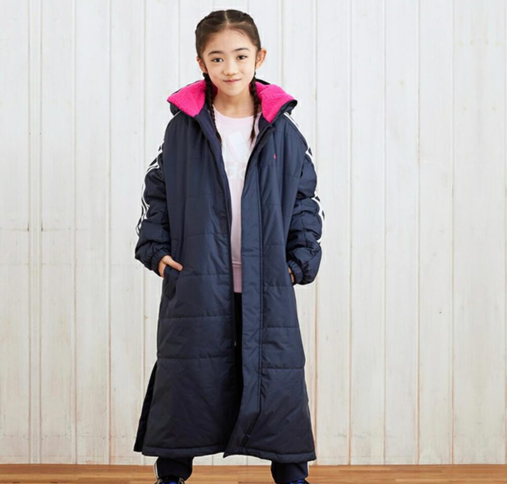 Adidas Kids' navy blue long puffer coat with pink fleece lining, white Adidas stripes on the sleeves, and a hood