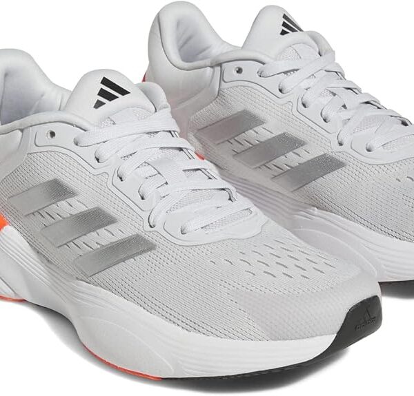 Adidas women's running shoes in white with silver stripes and an orange heel accent, featuring a breathable mesh upper and cushioned sole.