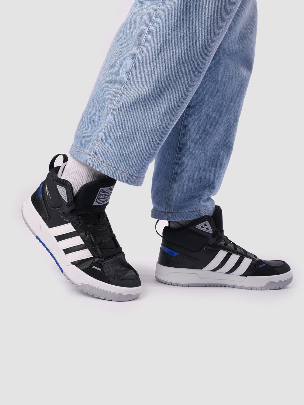 Adidas black and white high-top sneakers with three white stripes, blue accents, and a cushioned sole, perfect for casual streetwear or athletic use.