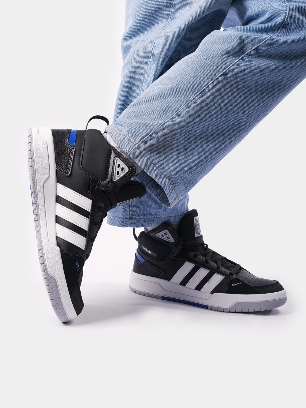 Adidas black and white high-top sneakers with three white stripes, blue accents, and a cushioned sole, perfect for casual streetwear or athletic use.