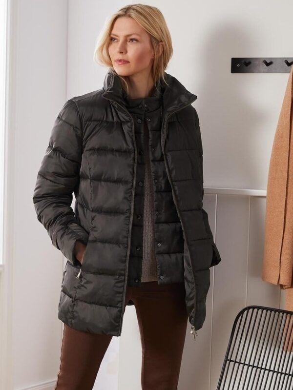 Women's black quilted longline puffer jacket with high-neck collar and zippered pockets, ideal for cold weather