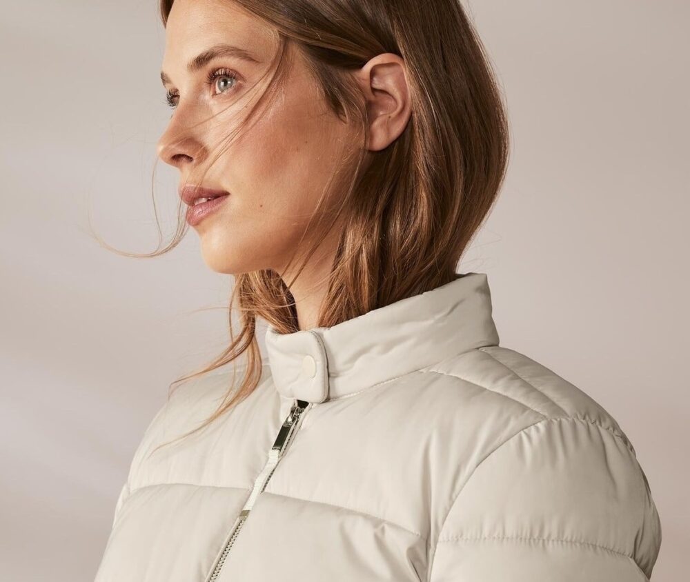 Tchibo women's beige padded jacket featuring a quilted design, zip-up front, elasticated cuffs, and side pockets, perfect for lightweight comfort and modern style.