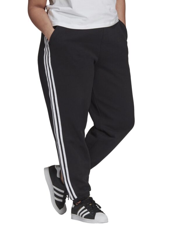 Adidas black plus-size track pants with white 3-stripes and the Adidas Trefoil logo, worn with Adidas Superstar sneakers.