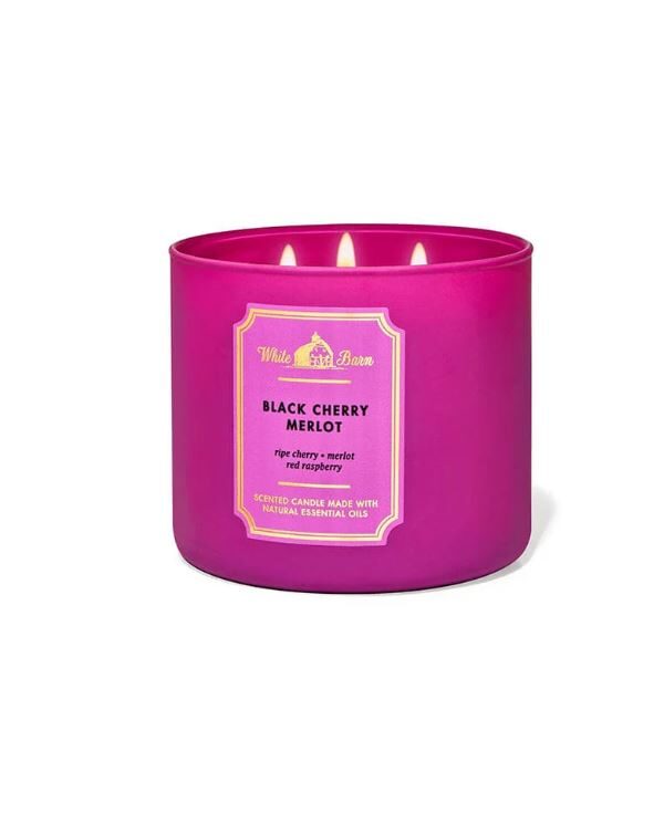 White Barn Black Cherry Merlot 3-Wick Candle in a pink glass jar with a gold label.