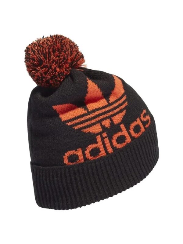 Adidas black and orange knit beanie with trefoil logo and pom-pom detail.