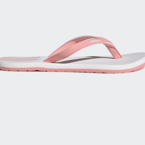 Adidas women's flip-flops in white with pink straps and iconic three-stripe branding, perfect for summer.