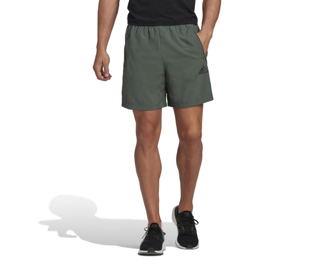 Adidas olive green athletic shorts with elastic waistband and logo detail.