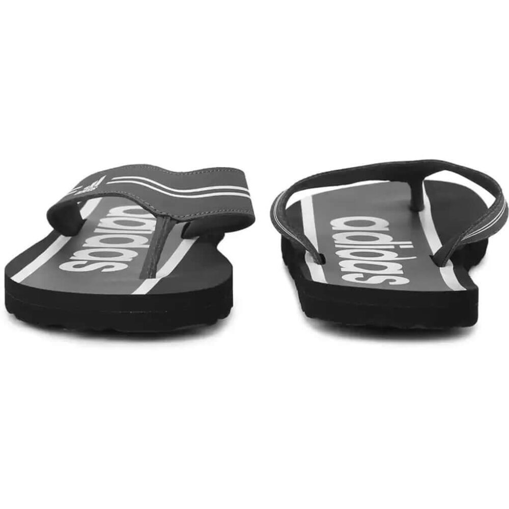 A pair of grey Adidas Adilette Comfort Flip Flops with the Adidas logo and 3-Stripes.