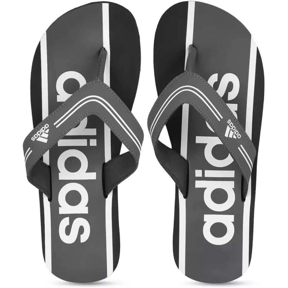 A pair of grey Adidas Adilette Comfort Flip Flops with the Adidas logo and 3-Stripes.