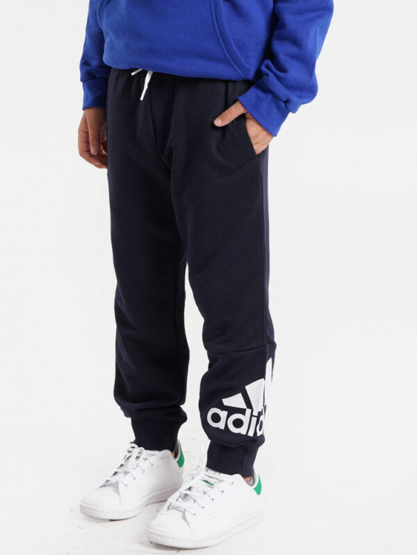Adidas kids' navy joggers with a large white logo on the leg and ribbed ankle cuffs.