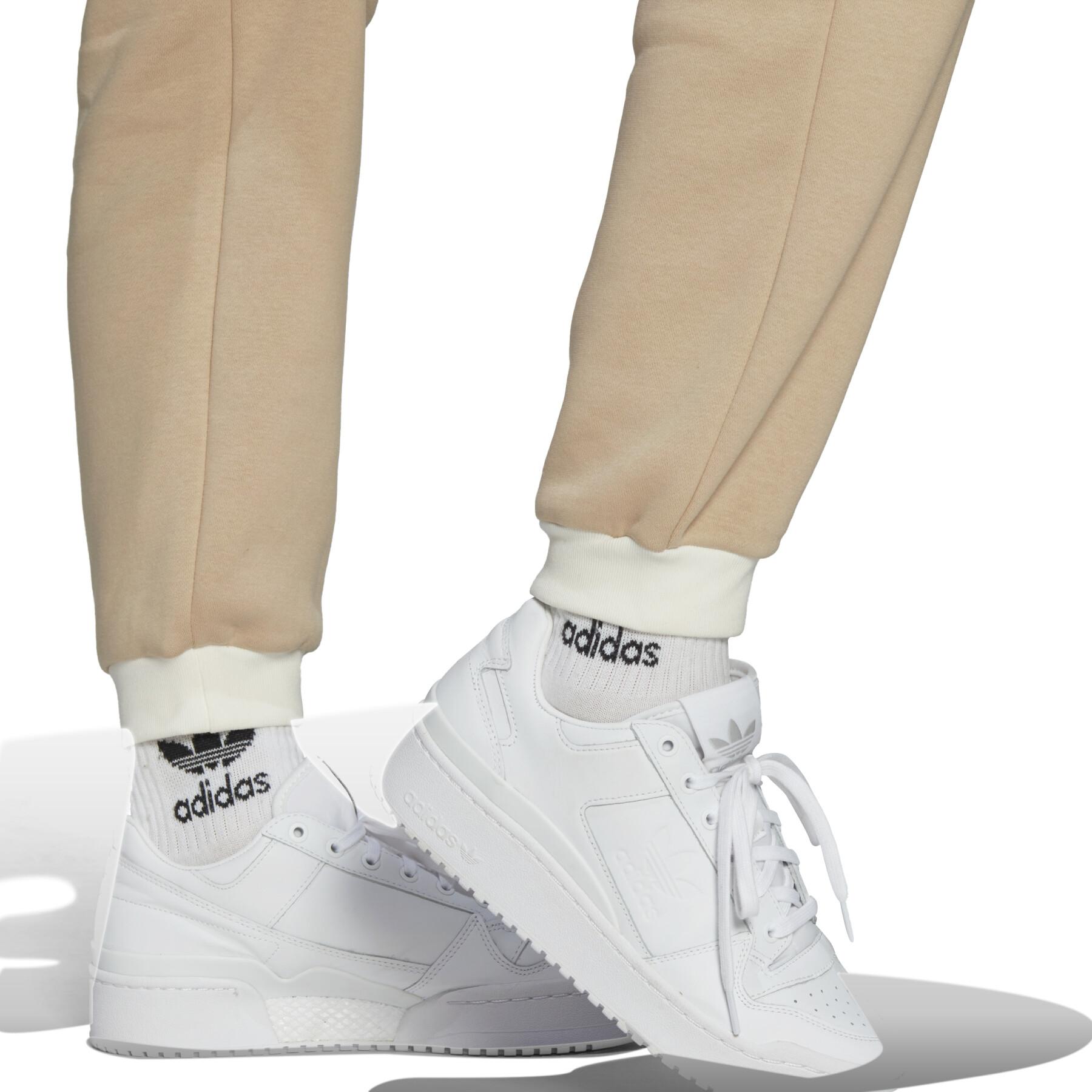 Beige Adidas sweatpants with a white Trefoil logo.
