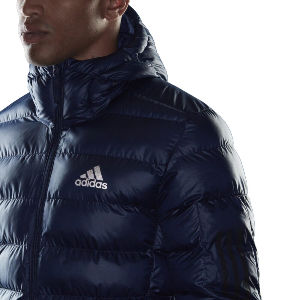 Navy blue Adidas puffer jacket with hood, quilted pattern, and full zipper.