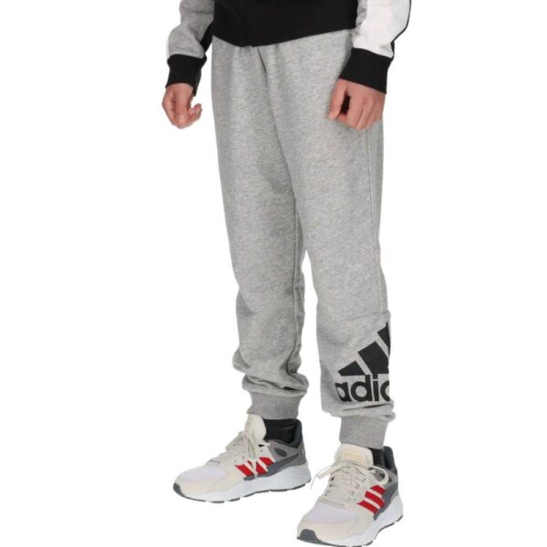 Adidas kids' grey joggers with black logo and ribbed ankle cuffs.