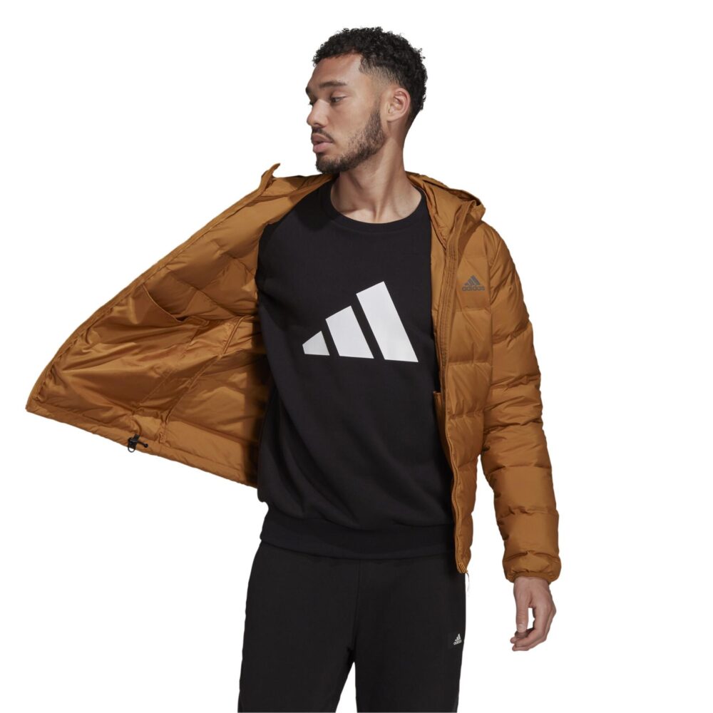 A tan Adidas Essentials Light Down Jacket with a hood and zippered pockets.