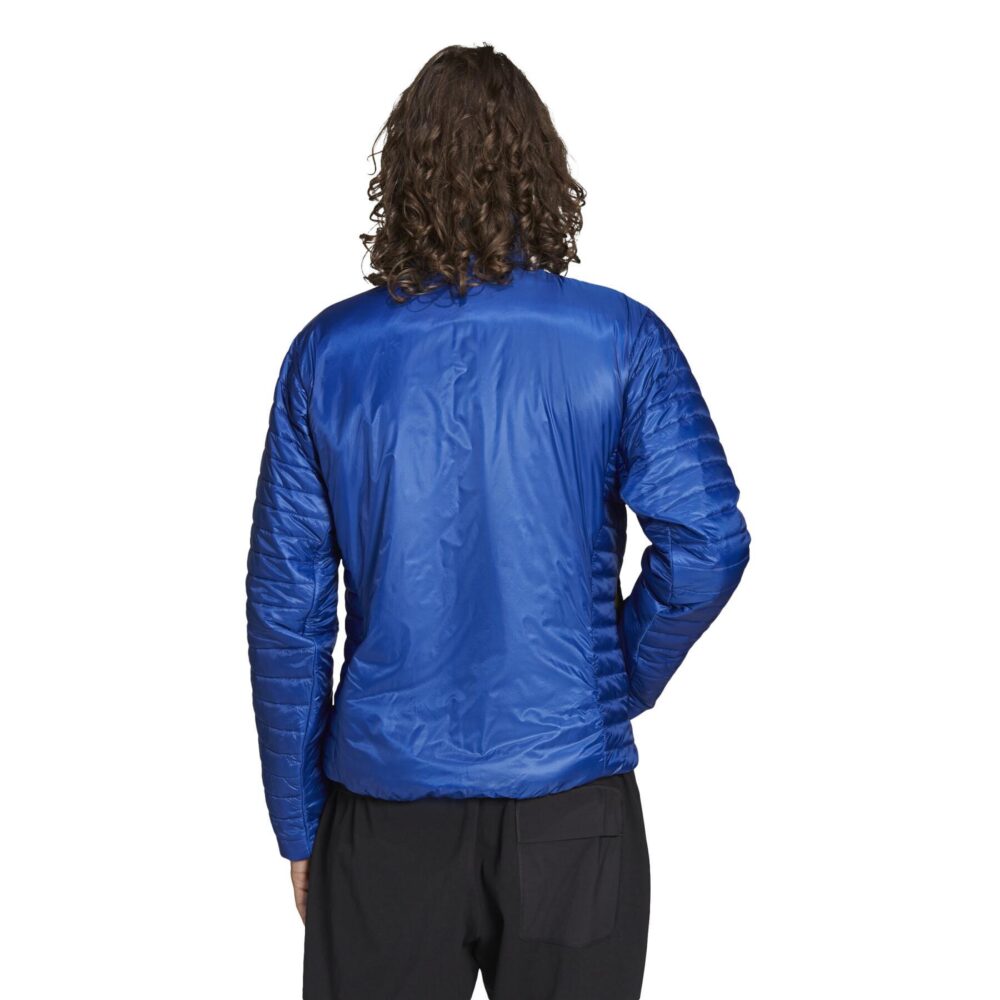 A man wearing an Adidas Terrex blue insulated jacket with a quilted design, full zip closure, and zippered pockets, ideal for outdoor adventures