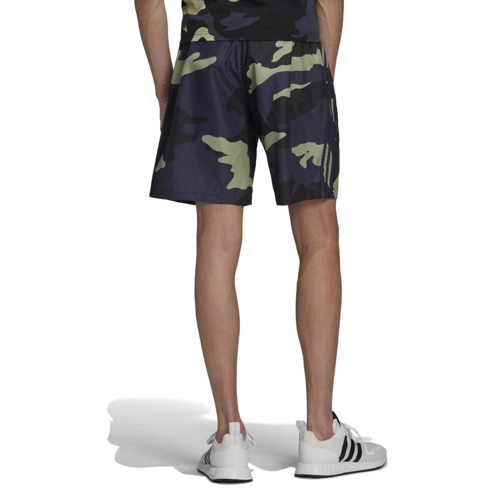 Adidas Men's Camo Print Shorts with an elastic waistband and side pockets, paired with white Adidas sneakers.