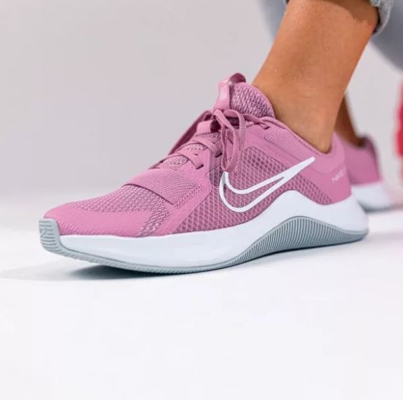 Nike women's pink training shoes with white Swoosh logo and cushioned sole.