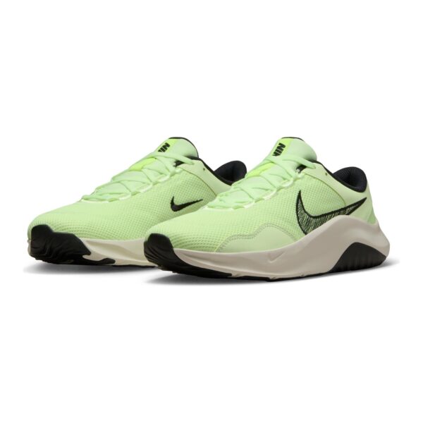Nike women's light green running shoes with black Swoosh logo and cushioned sole.