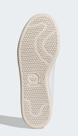 A pair of white Adidas Stan Smith Shoes with a colorful heel tab. A pair of white Adidas Stan Smith Shoes with a colorful heel tab. A pair of white Adidas Stan Smith Shoes with a colorful heel tab.