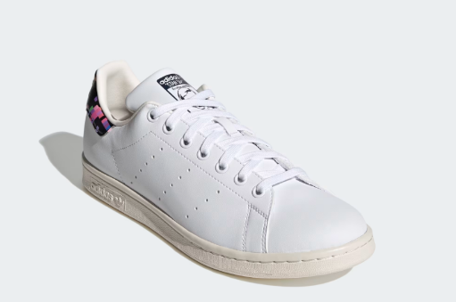 A pair of white Adidas Stan Smith Shoes with a colorful heel tab.