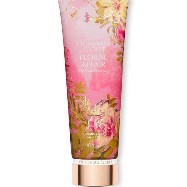 A pink and gold tube of Victoria's Secret Floral Affair Lily & Blush Berries lotion. The tube features an illustration of flowers and a butterfly, with the brand name and product name prominently displayed.