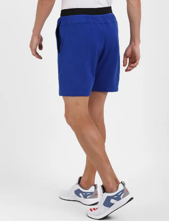 A person wearing solid blue Adidas City Functional Training Shorts.