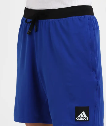 A person wearing solid blue Adidas City Functional Training Shorts.