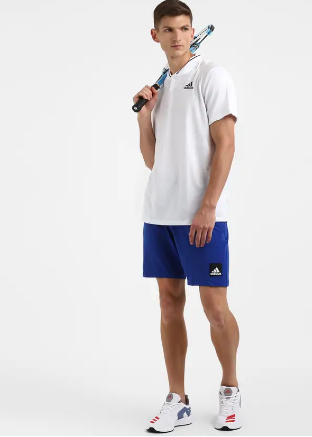 A person wearing solid blue Adidas City Functional Training Shorts.